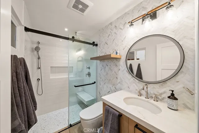 a bathroom with a sink toilet and shower