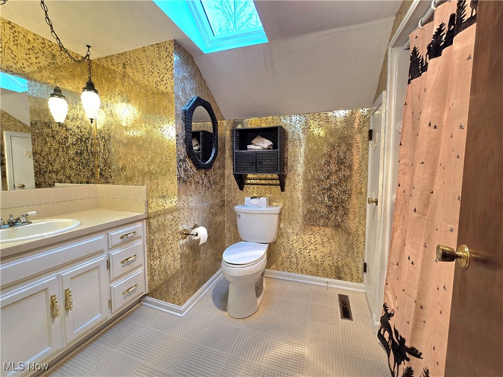 4300 Poe Road Medina, OH 44256 - Photo 30 of 45 Full bath with a skylight, vanity, wallpapered walls, a shower with shower curtain