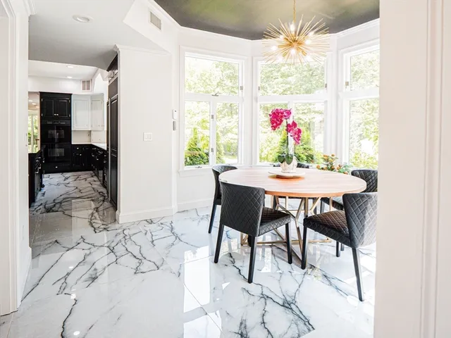 a dining room with furniture a chandelier and a rug