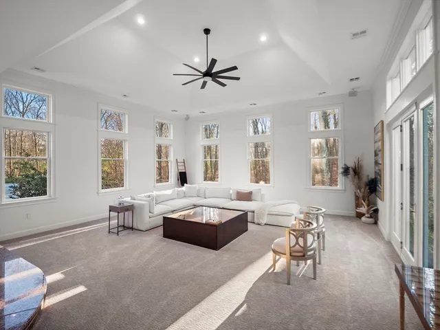 a living room with furniture and a chandelier