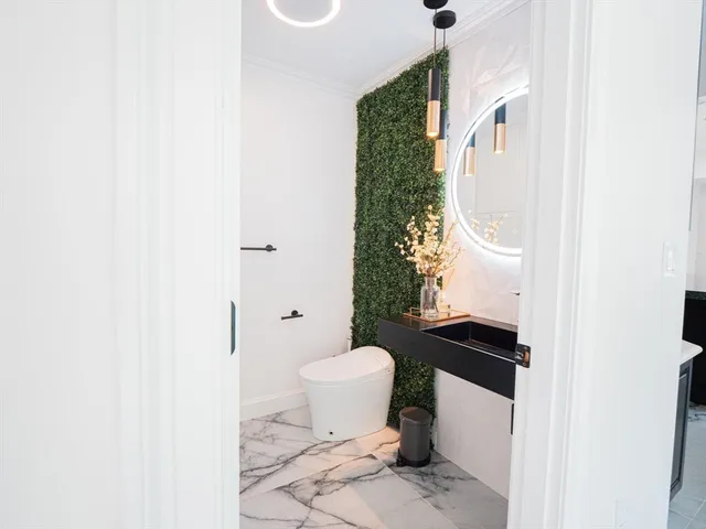 a bathroom with a sink toilet and a mirror