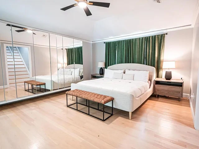 a spacious bedroom with a bed a couch and a window