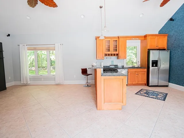 a kitchen with stainless steel appliances granite countertop a stove a sink and a refrigerator