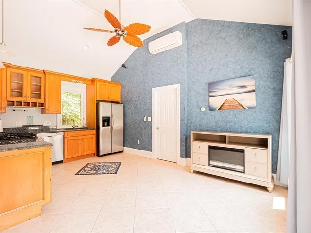 a view of a kitchen with a stove cabinets and a floor to ceiling window