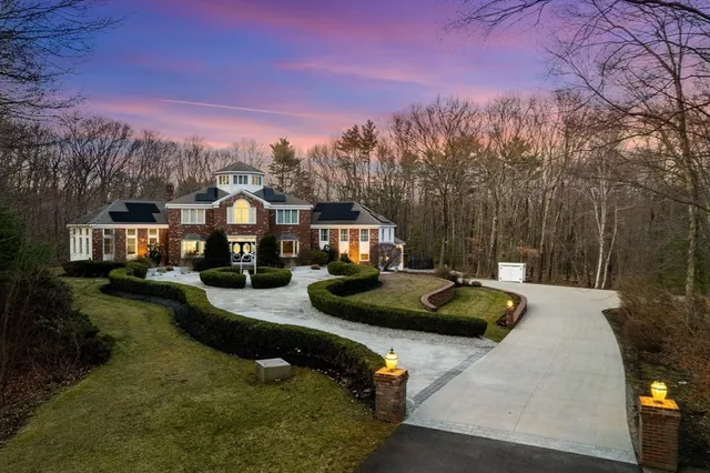 a view of a house with swimming pool and sitting area