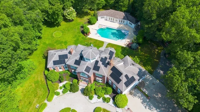 an aerial view of a house with a garden and trees
