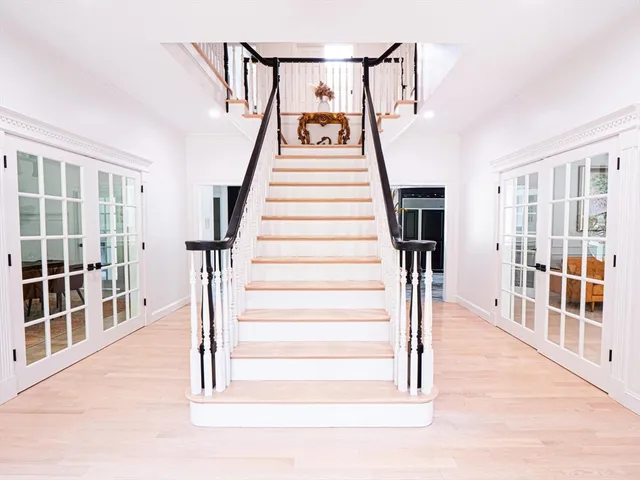 a view of entryway and hall with wooden floor