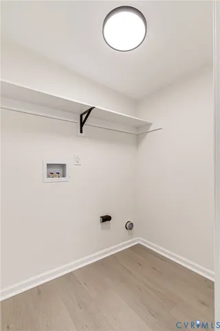 a bedroom with bed and window with chair