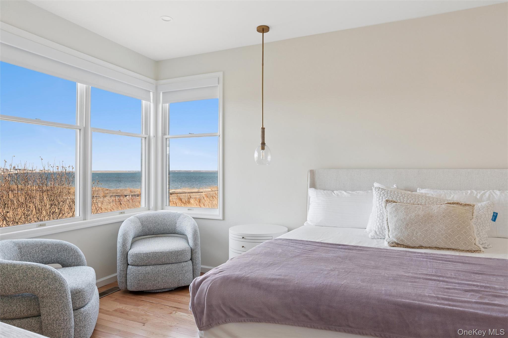 580 Dune Road, Unit 3 Westhampton Beach, NY 11978 - Photo 15 of 36 a bedroom with furniture a bed and a large window