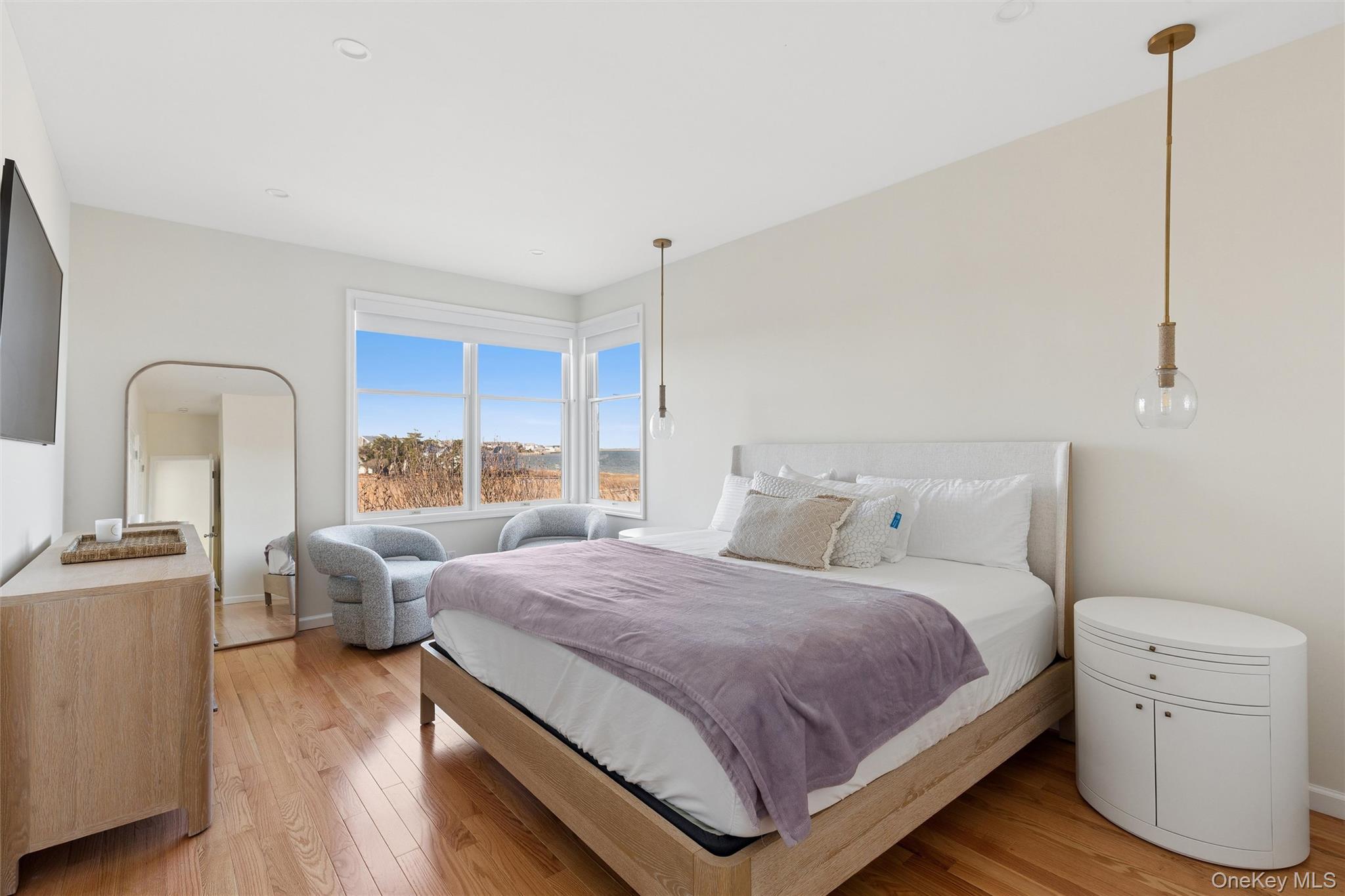 580 Dune Road, Unit 3 Westhampton Beach, NY 11978 - Photo 16 of 36 a bedroom with a bed and a cabinets