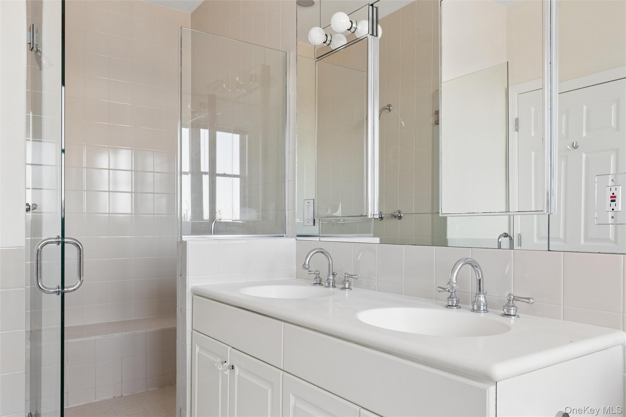 580 Dune Road, Unit 3 Westhampton Beach, NY 11978 - Photo 21 of 36 a bathroom with a sink and a mirror