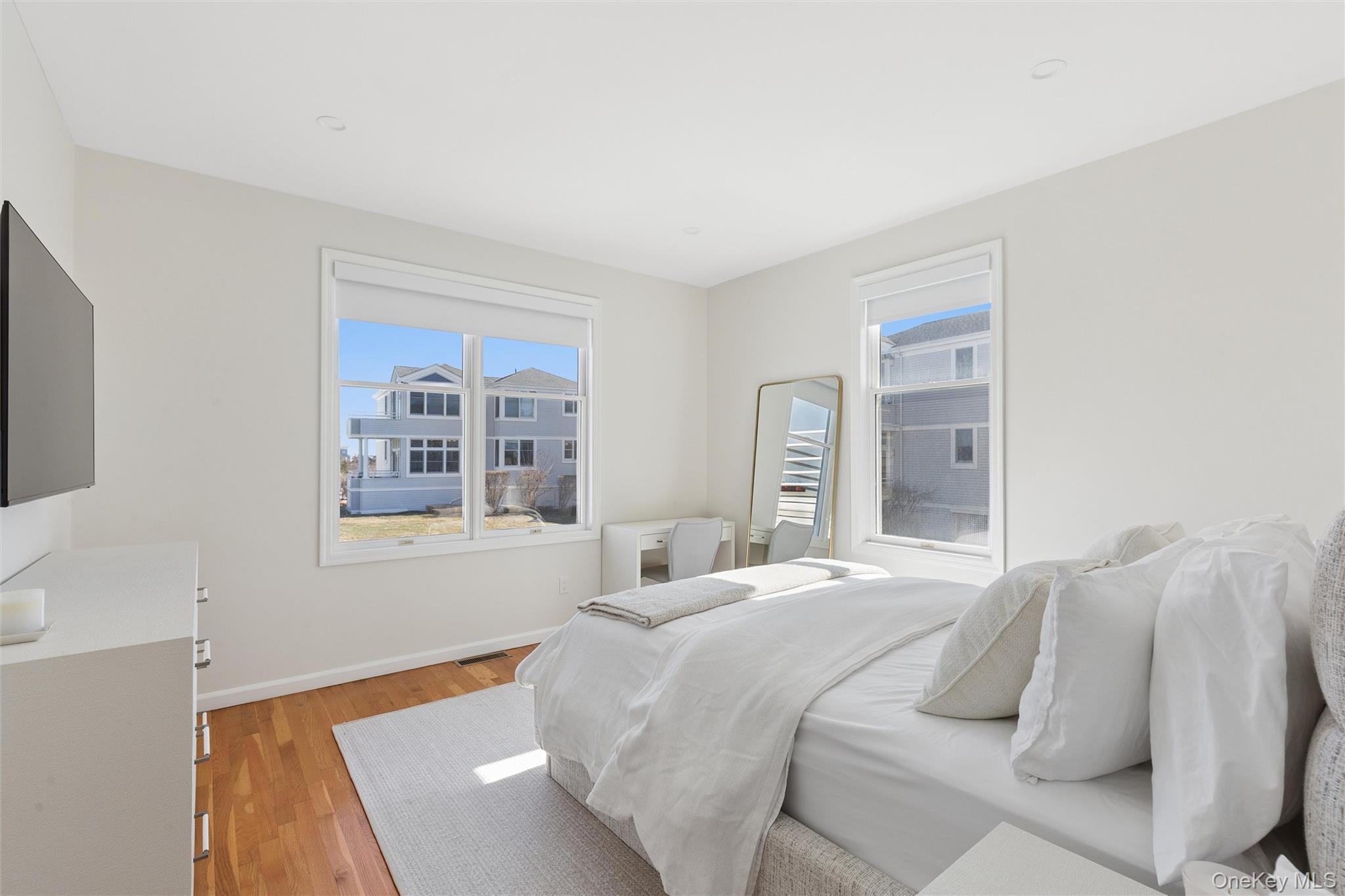 580 Dune Road, Unit 3 Westhampton Beach, NY 11978 - Photo 22 of 36 a bedroom with a bed and a window