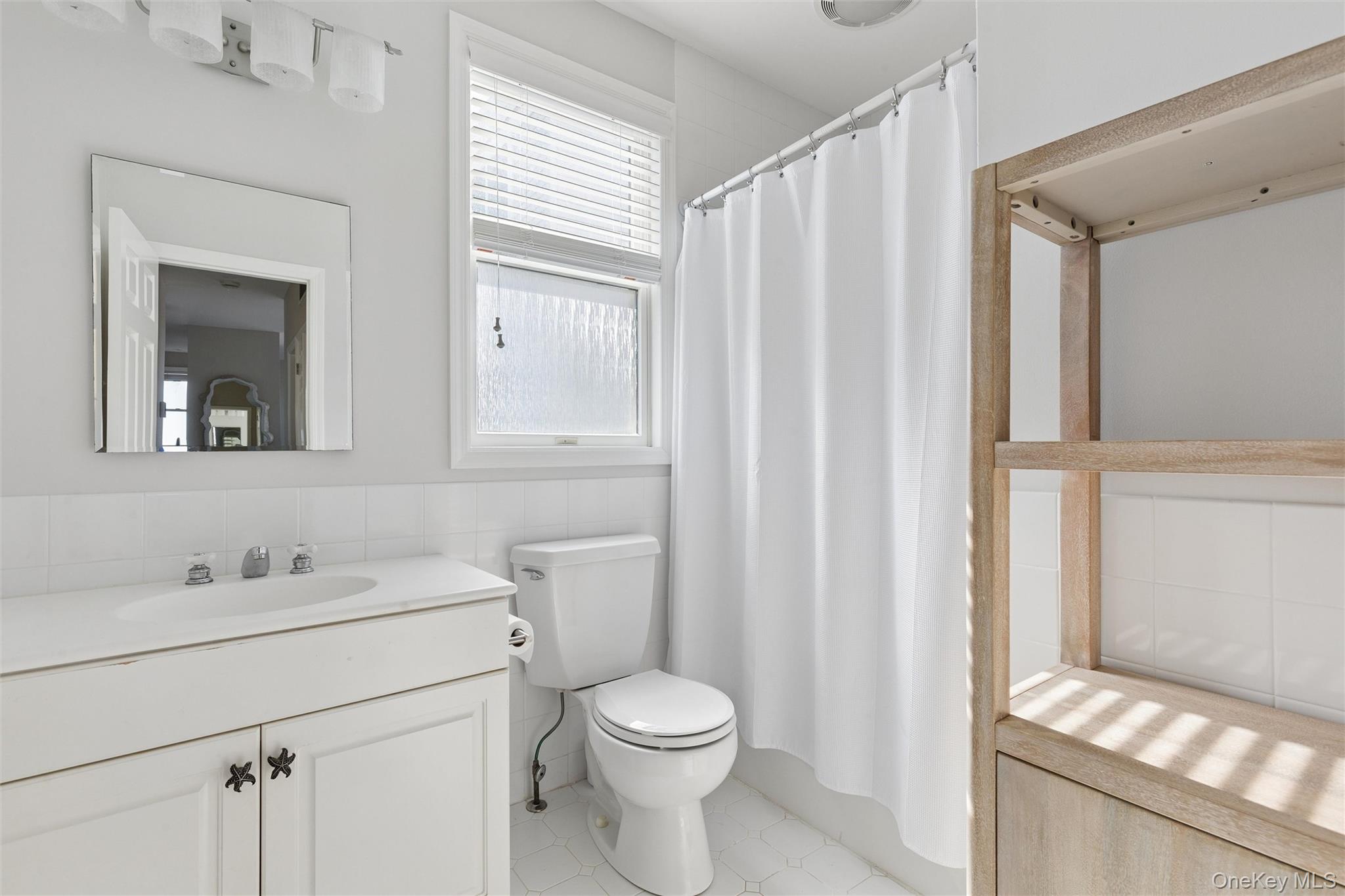 580 Dune Road, Unit 3 Westhampton Beach, NY 11978 - Photo 24 of 36 a bathroom with a sink a toilet and shower