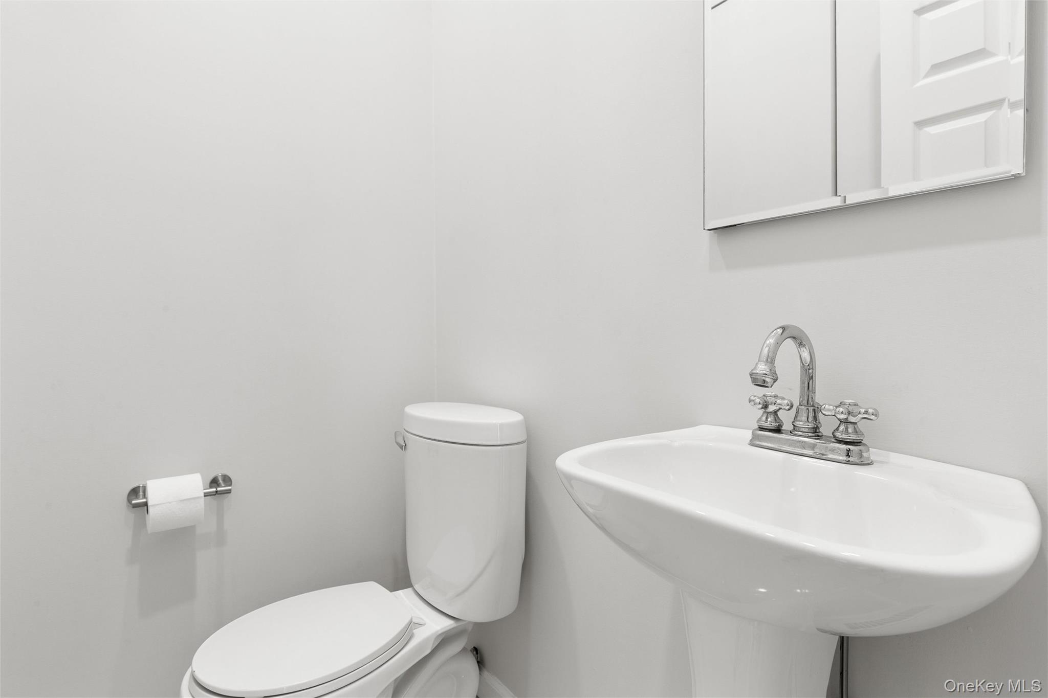 580 Dune Road, Unit 3 Westhampton Beach, NY 11978 - Photo 26 of 36 a bathroom with a sink a toilet and mirror