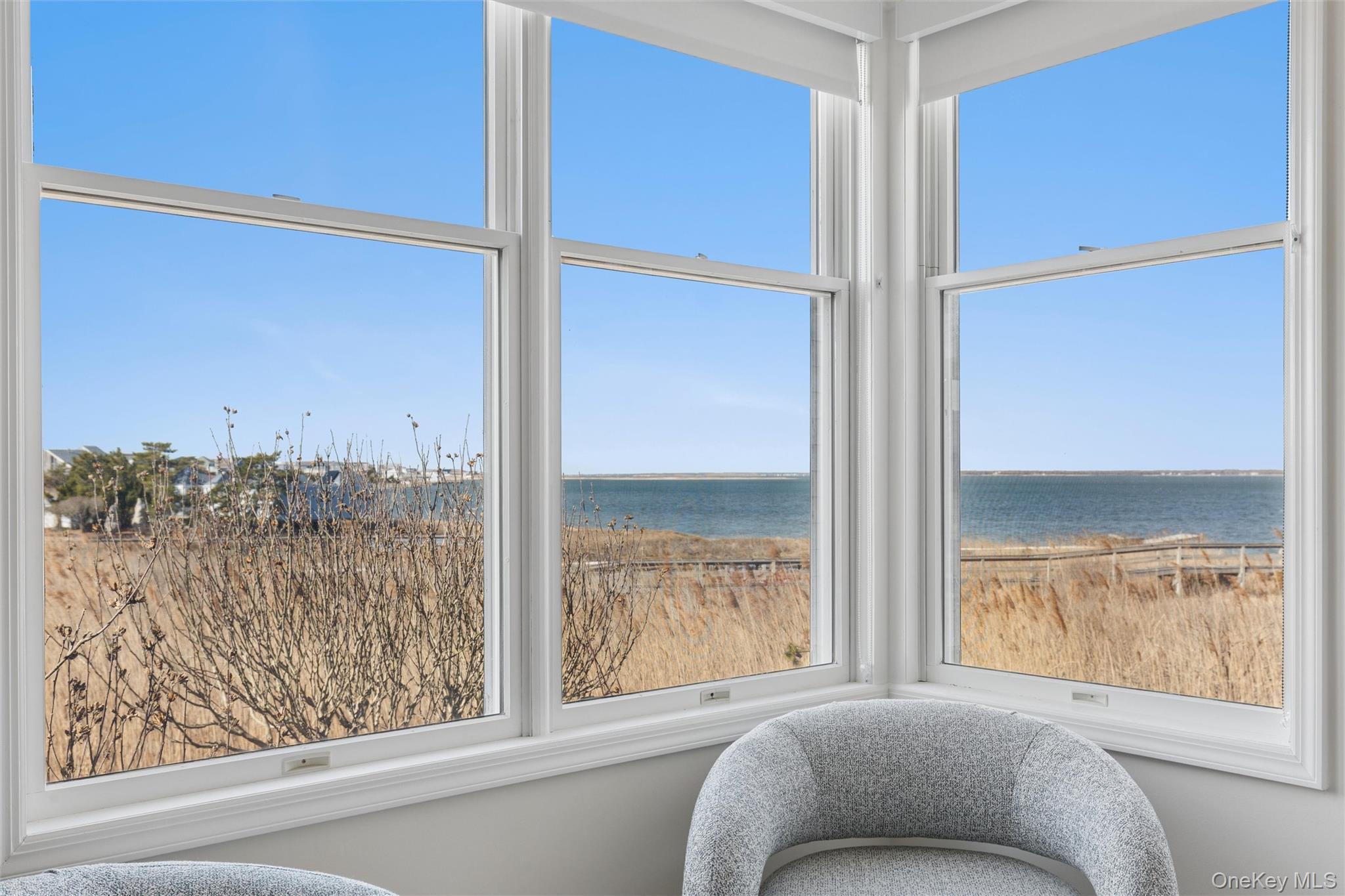580 Dune Road, Unit 3 Westhampton Beach, NY 11978 - Photo 4 of 36 a bedroom with a bed and a window