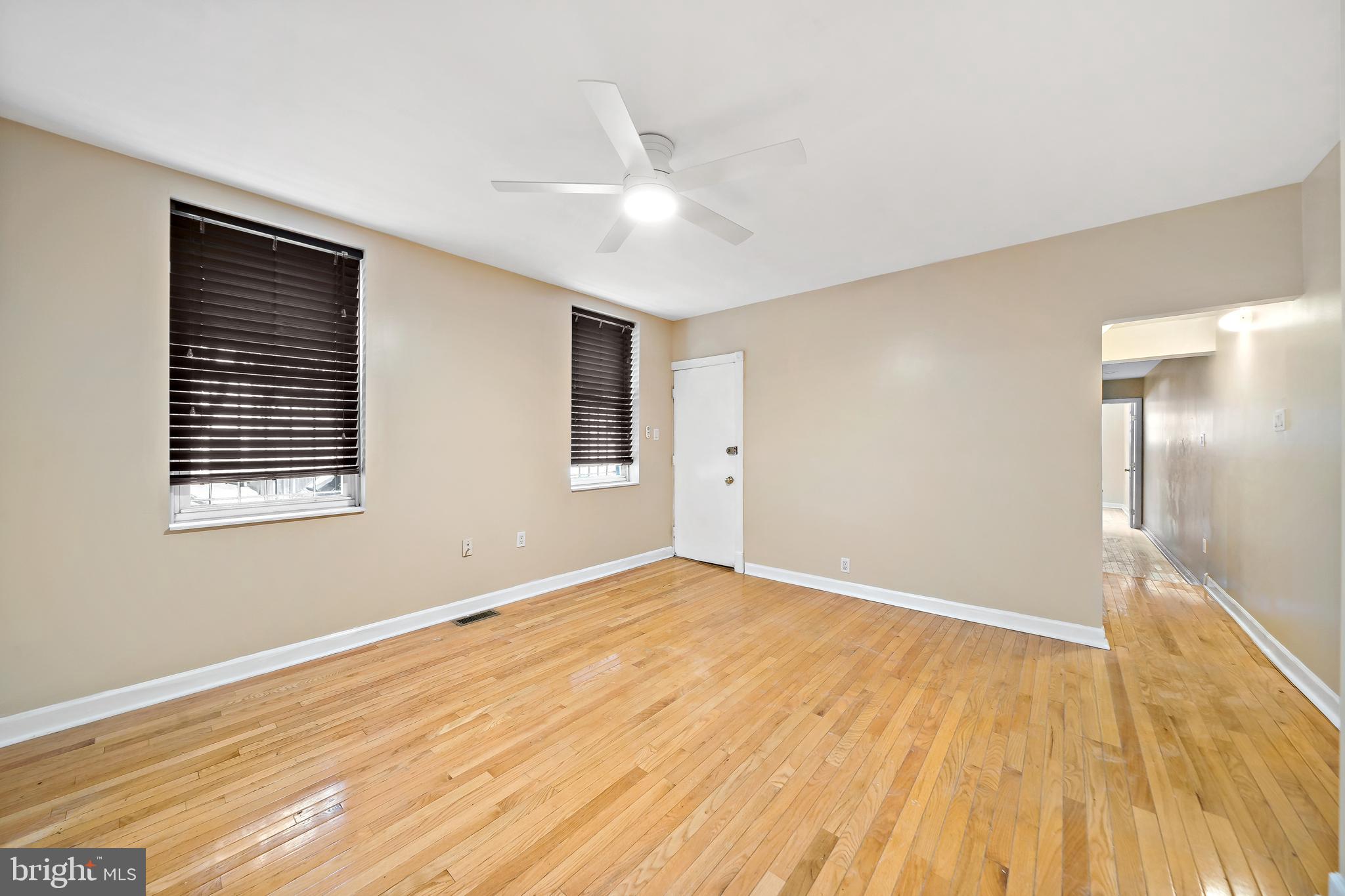 926 East Passyunk Avenue, Unit 1 Philadelphia, PA 19147 - Photo 12 of 19 a view of an empty room with wooden floor and a window