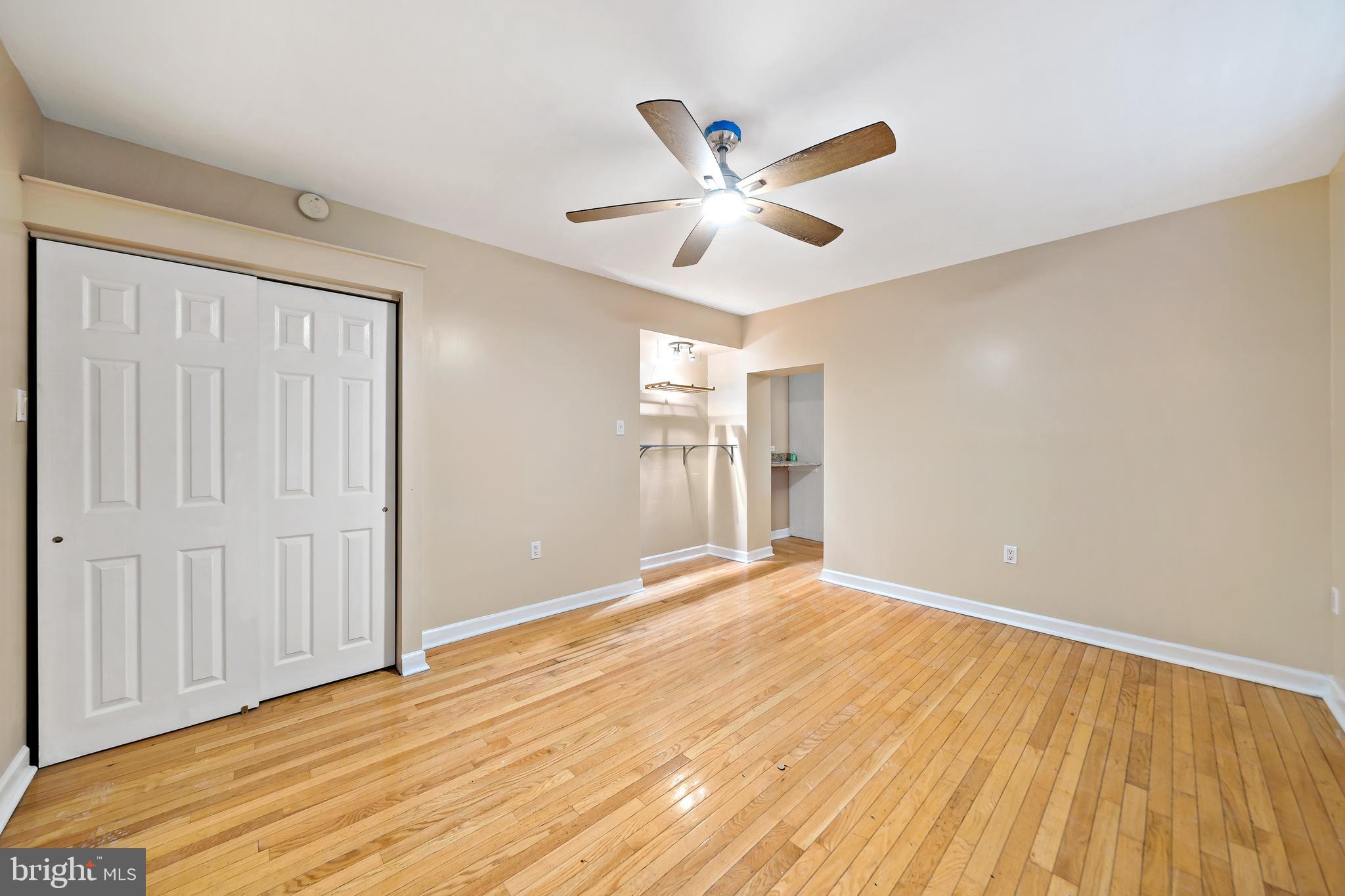 926 East Passyunk Avenue, Unit 1 Philadelphia, PA 19147 - Photo 13 of 19 a view of an empty room with wooden floor and a window