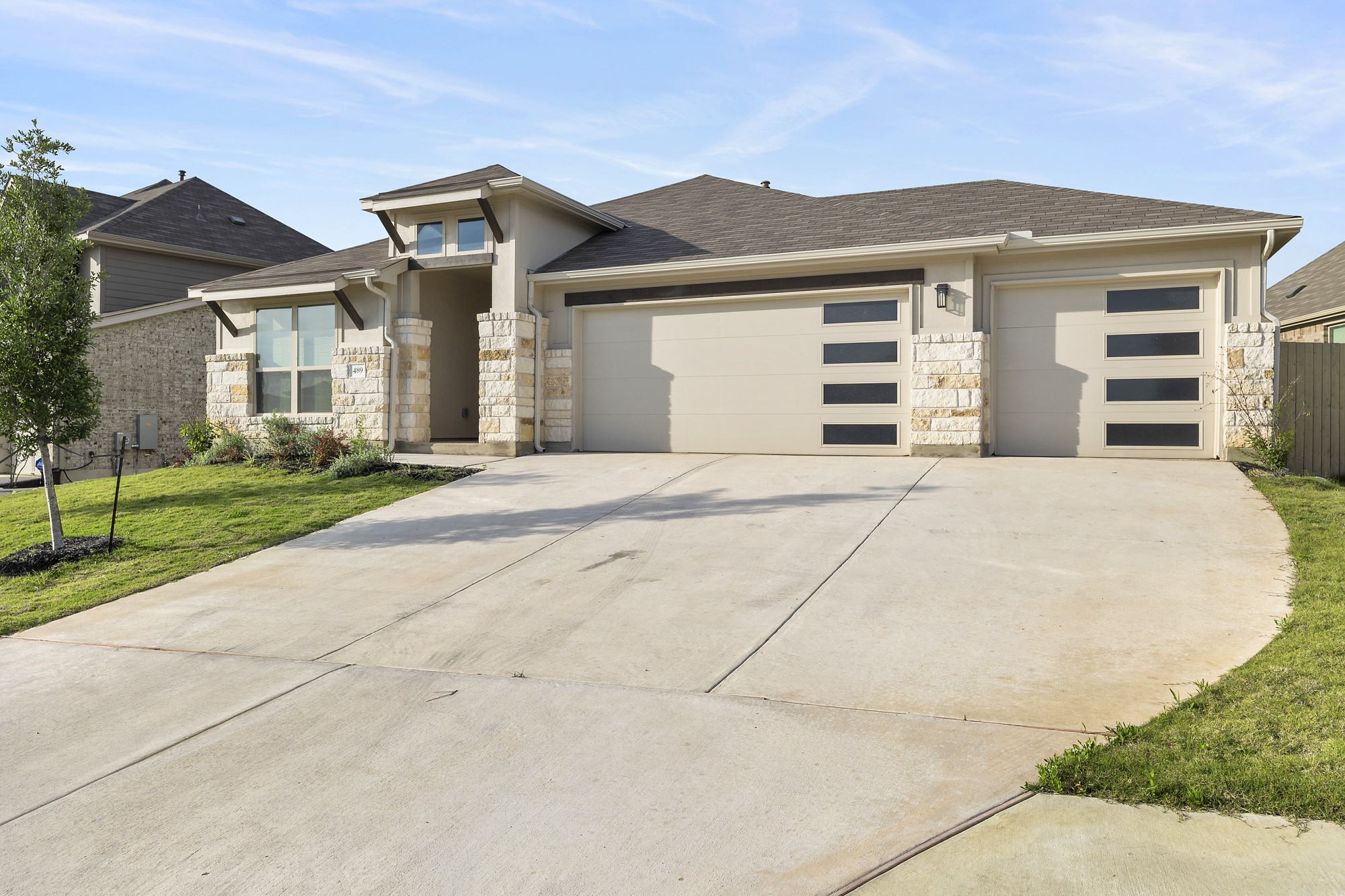 a front view of a house with a garden