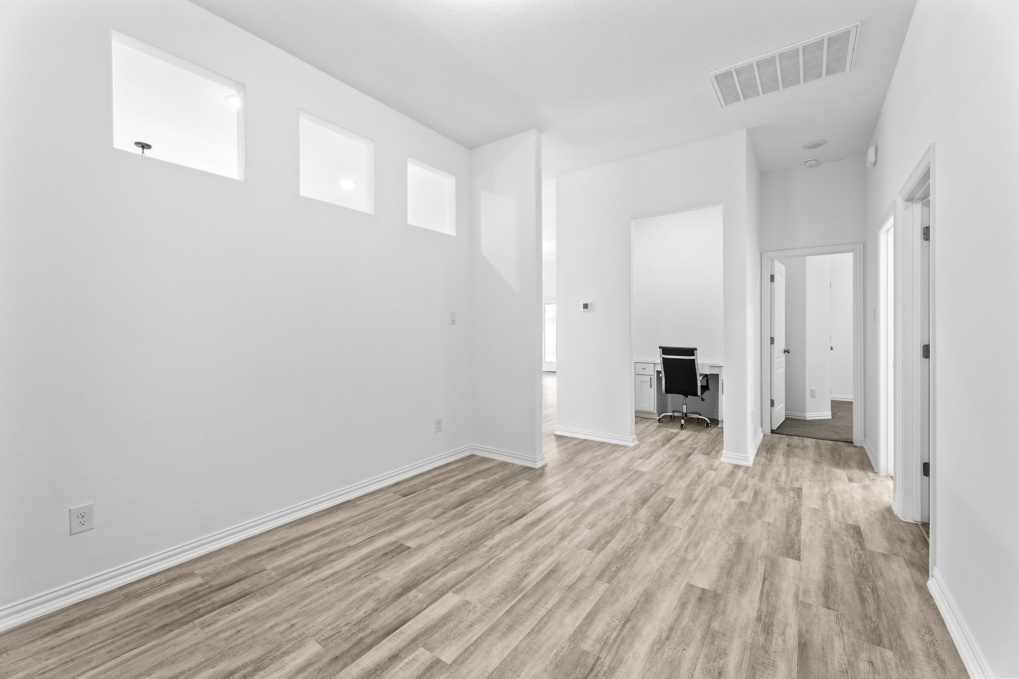 489 Cherrystone Loop Buda, TX 78610 - Photo 11 of 21 a view of empty room with wooden floor