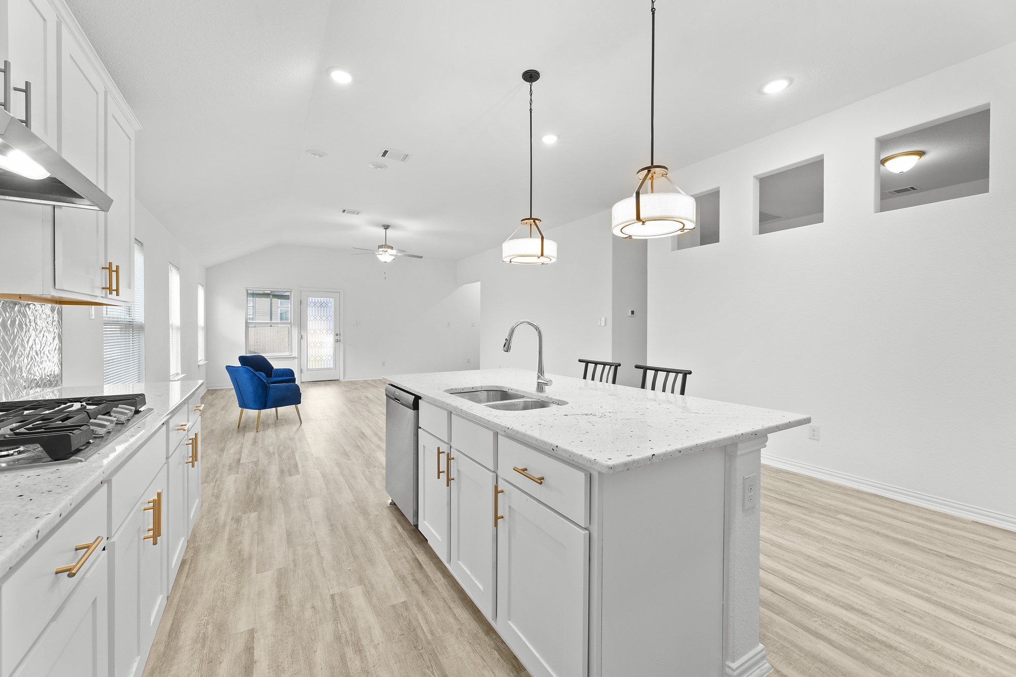 489 Cherrystone Loop Buda, TX 78610 - Photo 6 of 21 a kitchen with a sink stove and wooden floor