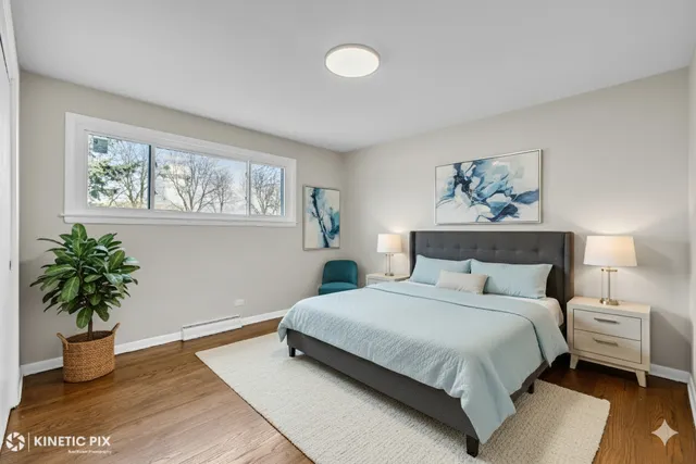 a bedroom with a bed and a potted plant