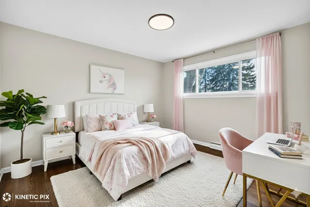 a bedroom with a bed and a potted plant
