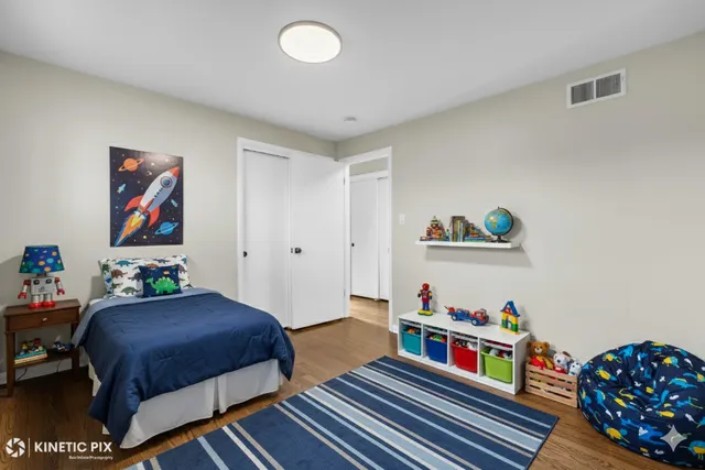 a bedroom with furniture and a book shelf