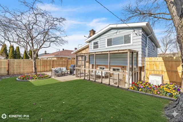 a front view of a house with a yard table and chairs