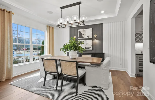 a view of a dining room with furniture and chandelier