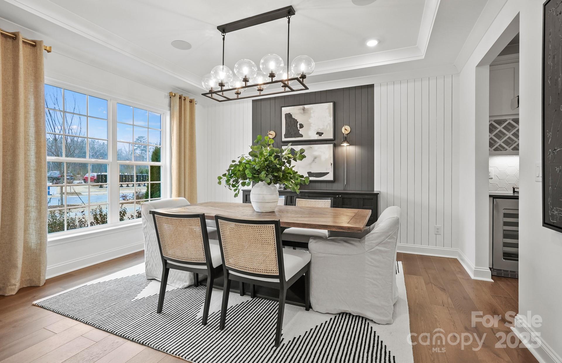 a view of a dining room with furniture and chandelier