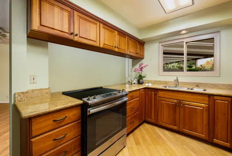 a kitchen with stainless steel appliances granite countertop a stove and cabinets