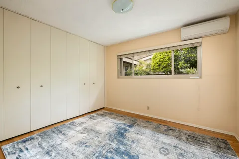 a view of room with window and wooden floor