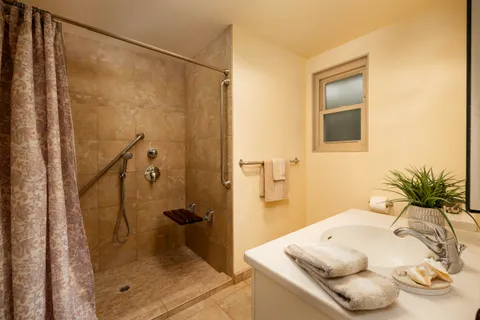 a bathroom with a tub shower and a sink