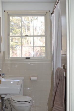 110 Boston Post Road Wayland, MA 01778 - Photo 16 of 20 a bathroom with a toilet a sink and a window