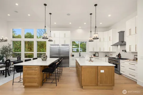 a large kitchen with kitchen island a large counter top space appliances and a center island