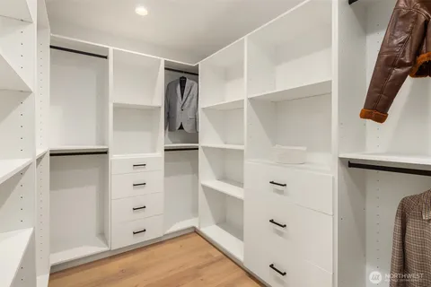 a view of walk in closet with empty racks