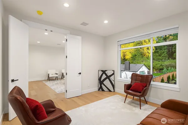a living room with furniture and a floor to ceiling window