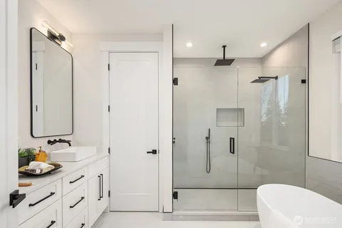 a bathroom with a granite countertop sink a toilet and shower
