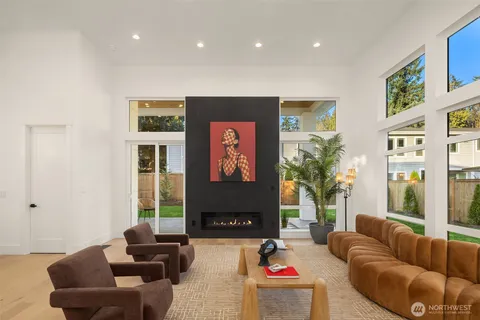 a living room with furniture potted plant and a large window