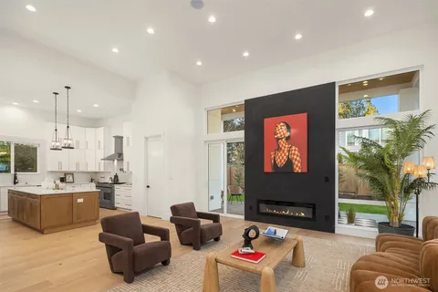 a living room with furniture kitchen view and a flat screen tv