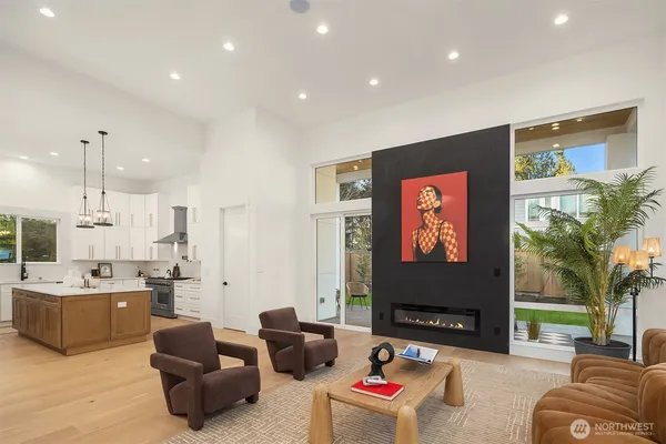 a living room with furniture kitchen view and a flat screen tv