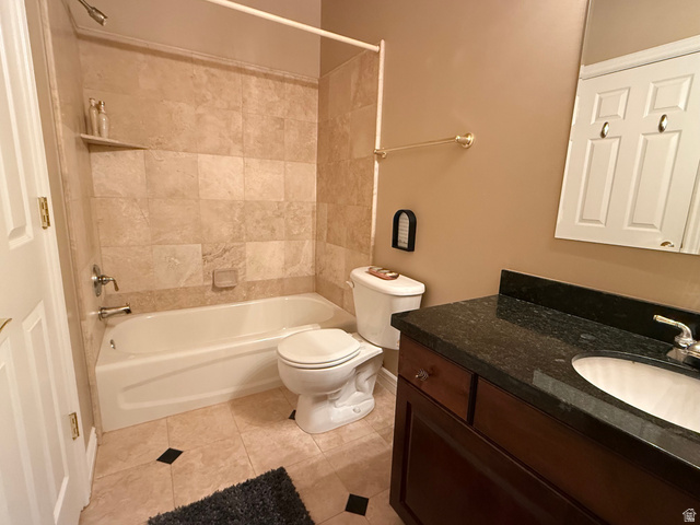 1562 Fairway Ridge Road Draper, UT 84020 - Photo 49 of 60 Bathroom featuring a tiled shower surround, integrated bathtub, and a dark wood vanity with a stone countertop and undermount sink