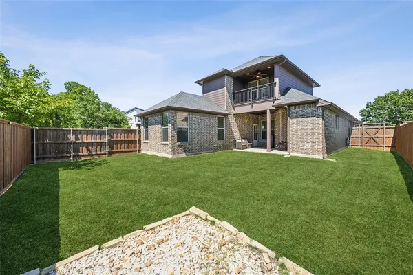 a front view of a house with a garden and yard