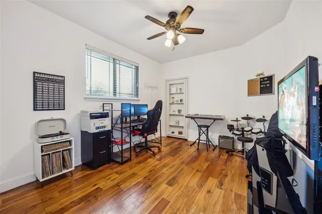 a view of a workspace with furniture and a flat screen tv