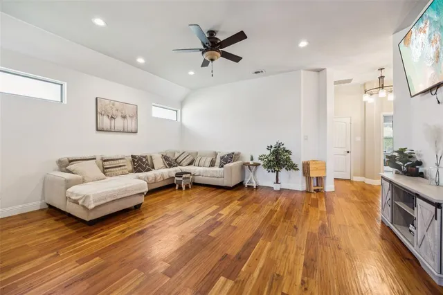 a living room with furniture and a wooden floor