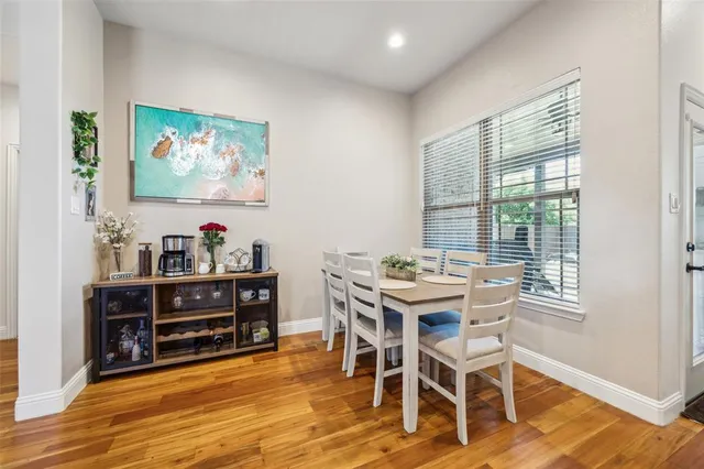 a view of a workspace with furniture and wooden floor