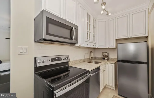 a kitchen with a stove microwave and refrigerator