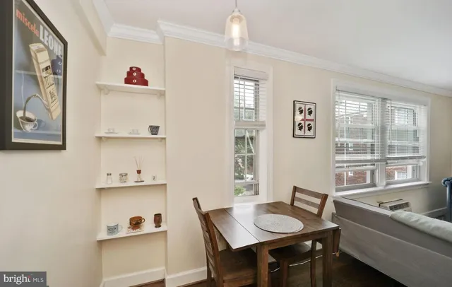 a view of a dining room with furniture and a window