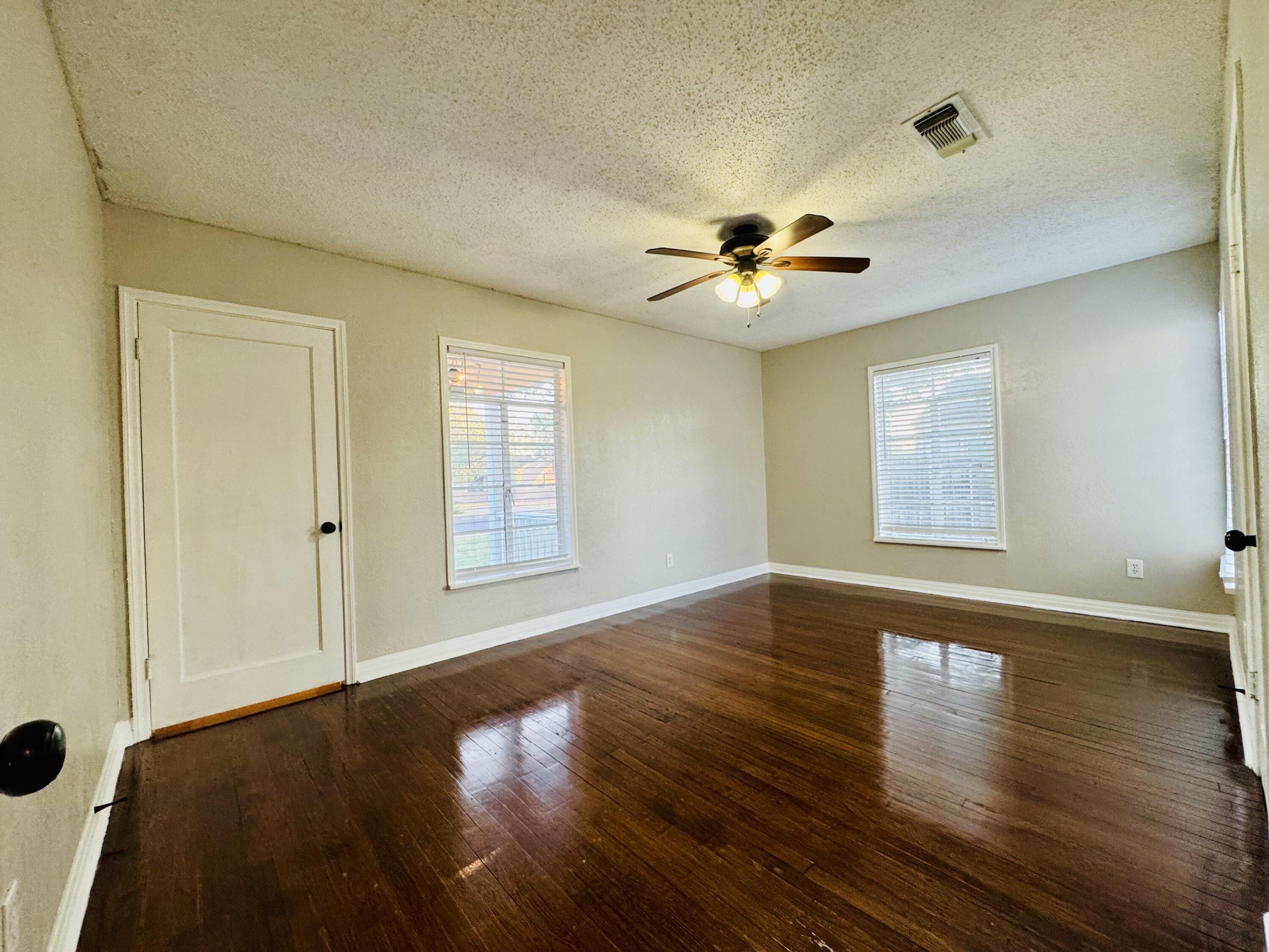 2509 30th Street Lubbock, TX 79410 - Photo 16 of 26 a view of empty room with wooden floor and fan