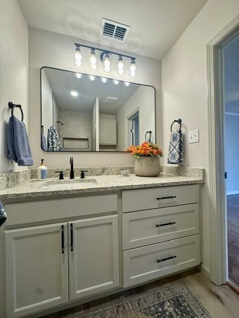 2509 30th Street Lubbock, TX 79410 - Photo 25 of 31 a bathroom with a sink and a mirror